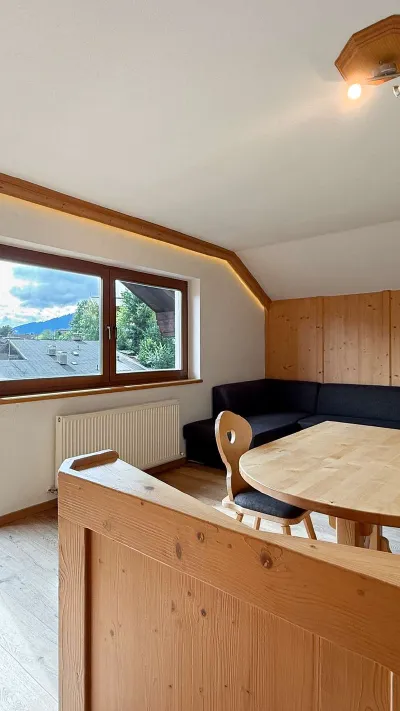 Sandro Anibas sitzt in einer luxuriösen Wohnung und schaut lächelnt von einer Zeitschrift auf
